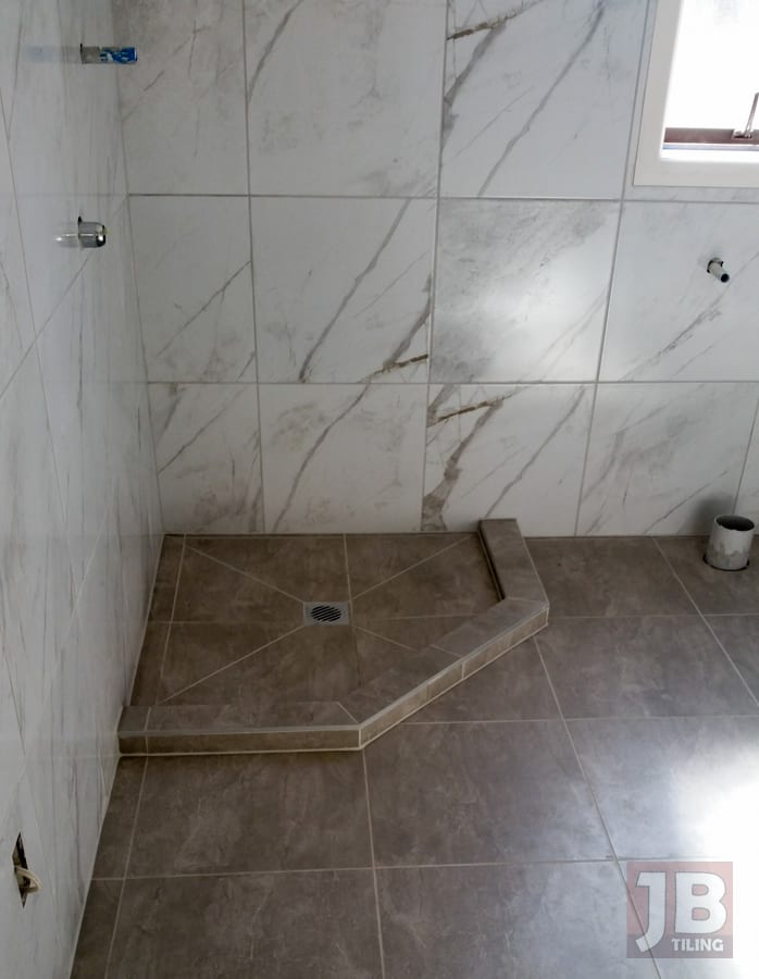 Bathroom tiled to the ceiling in a West Auckland home.