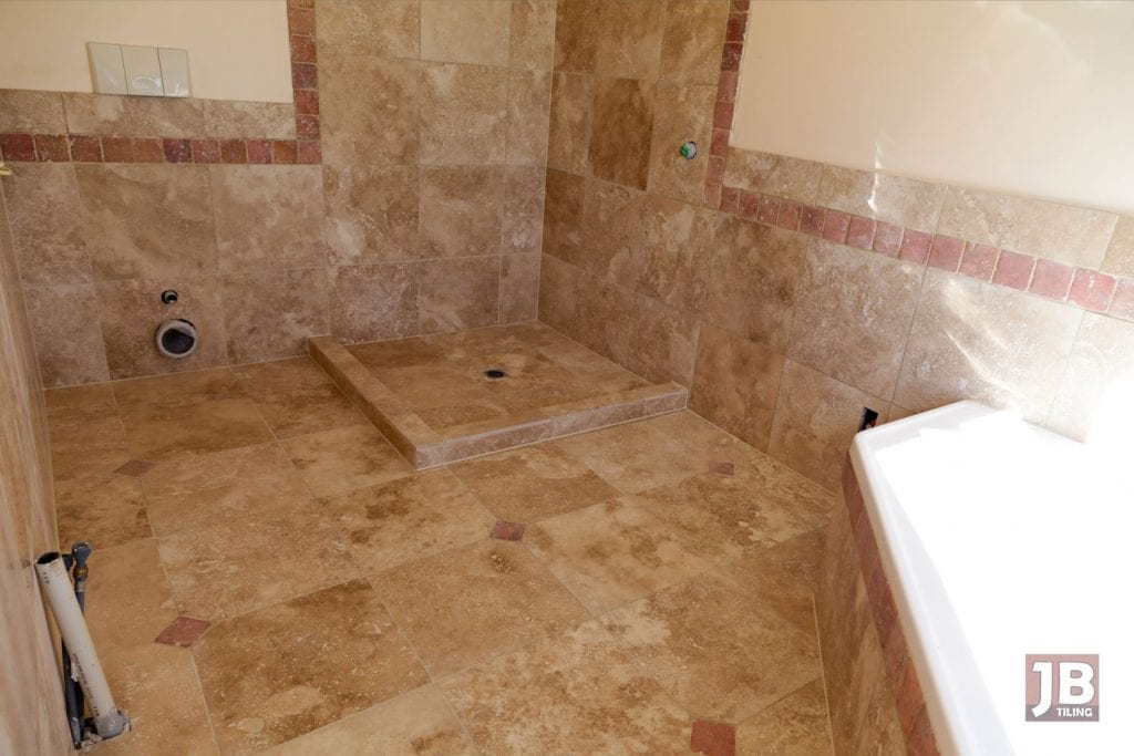 Travertine bathroom with full waterproofing installed.