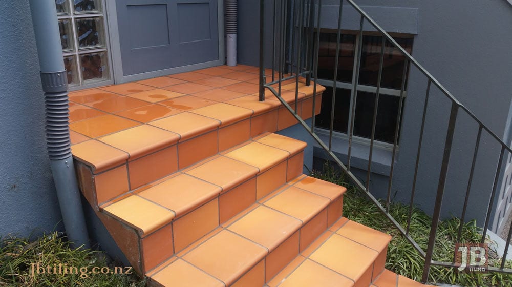 A residential property tiled with a terracotta tile on it's front entrance.