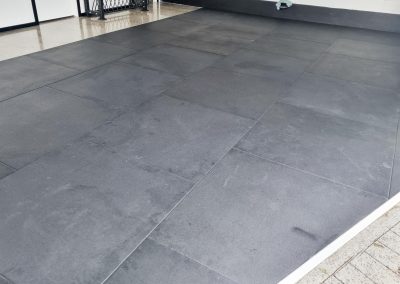 A physio therapy office with new black rubber gym mats installed in the rehab area.