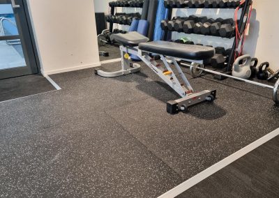 Weight equipment in a gym with new rubber flooring installed.